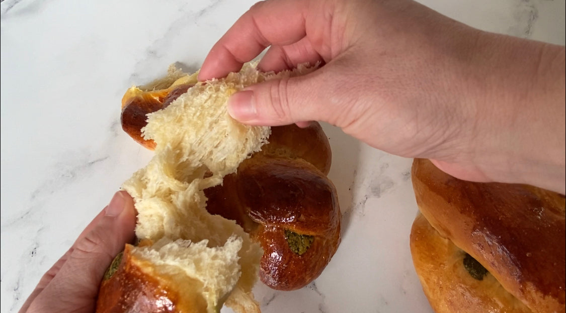 Close-up of rich braided challah with with mint leaves from Bend's premier Jewish bakery.