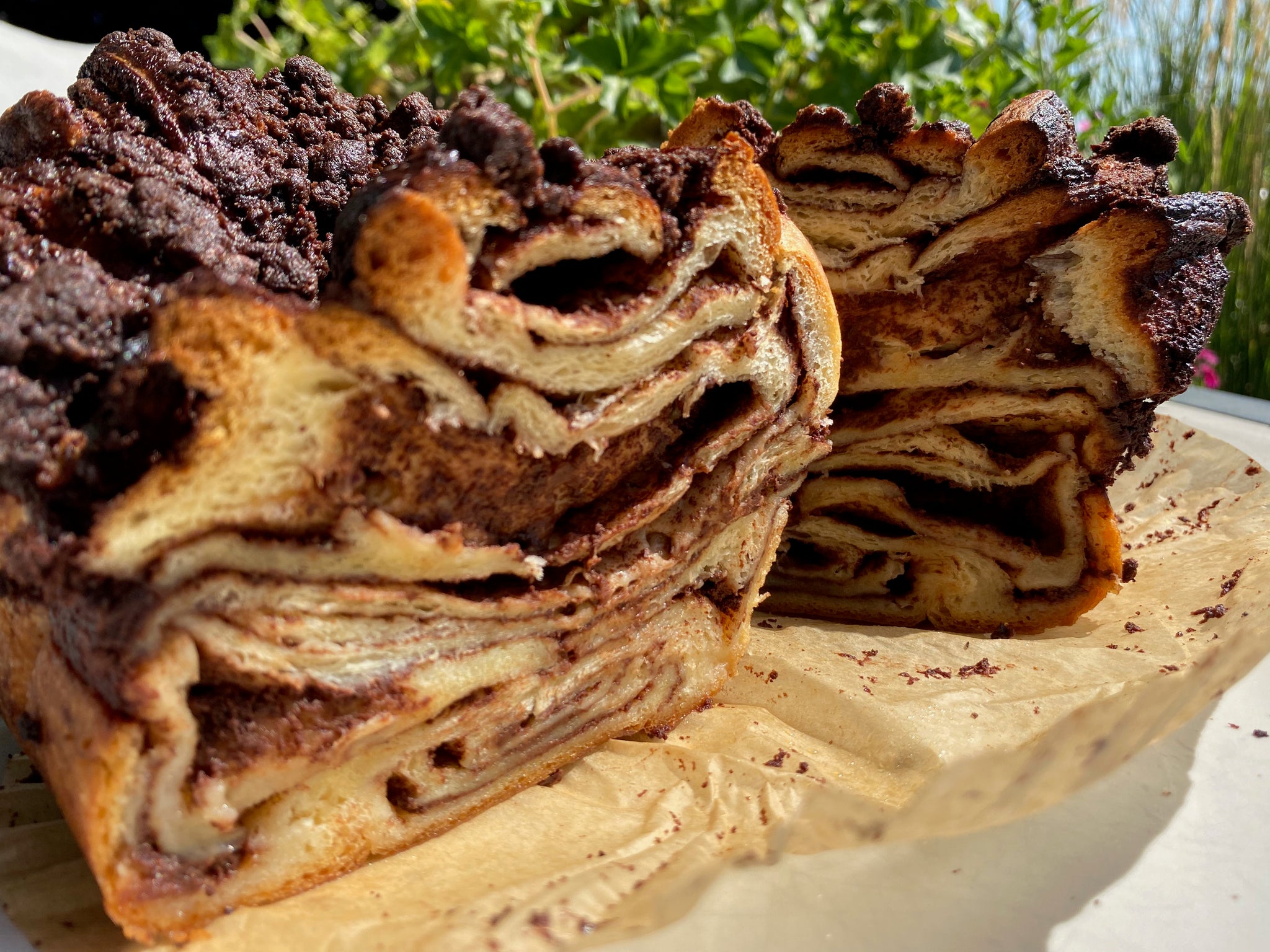 A slice of Dark Chocolate Babka from Bend's premier Jewish bakery, showcasing rich layers of dark chocolate ganache and a golden, fluffy crumb.