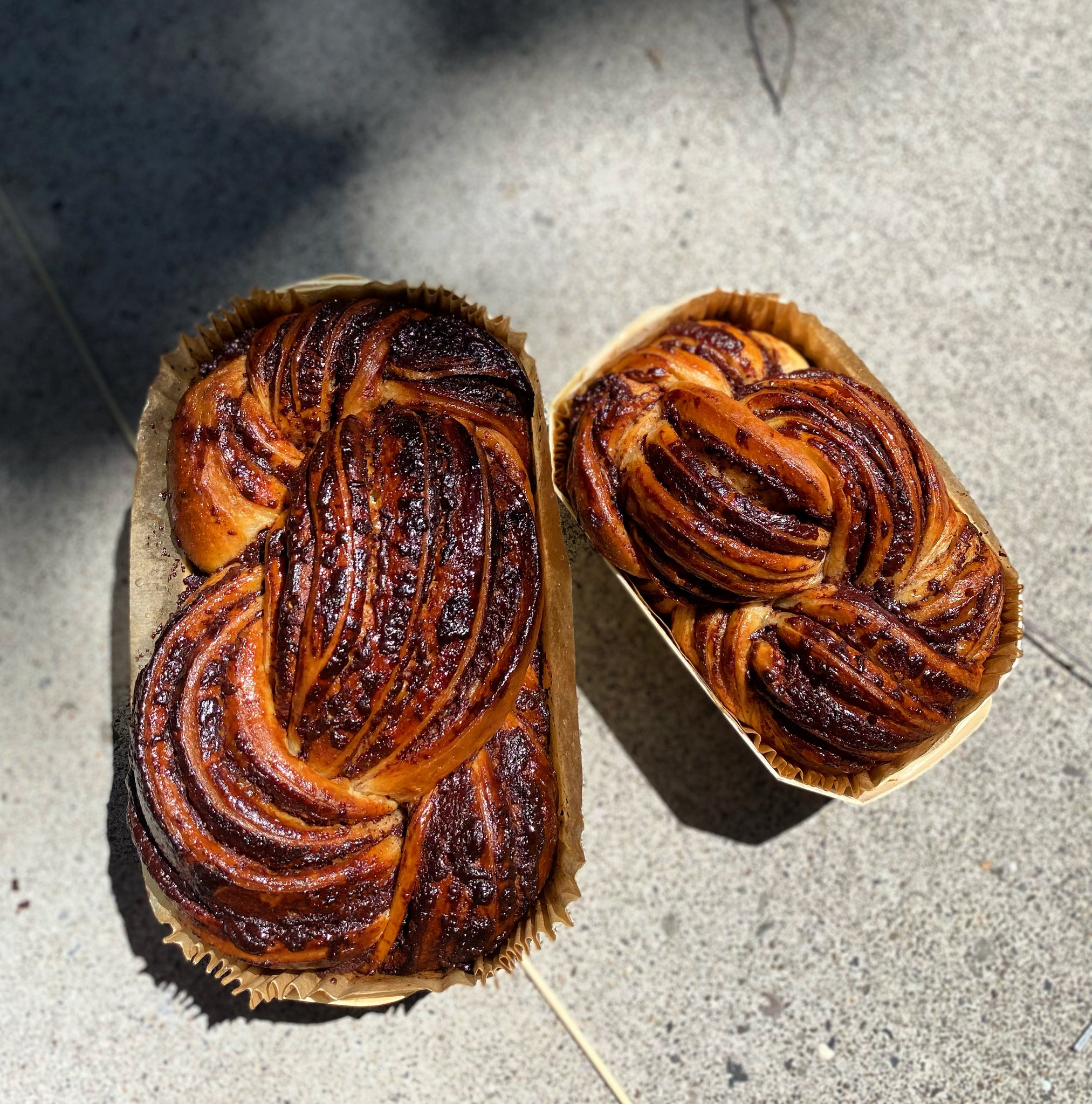 Large and Medium Dark Chocolate Babka from Bend's premier Jewish bakery, featuring rich swirls of dark chocolate ganache and lemon zest, no streusel. 